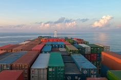 a large cargo ship loaded with containers in the ocean