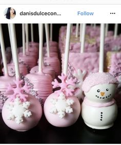 pink cake pops decorated with snowmen and frosting