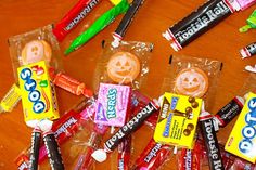 many candy bars are wrapped in plastic wrappers and have faces drawn on the top