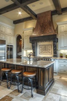 a kitchen with an island, stove and stools