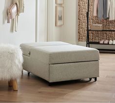 a footstool sitting on top of a hard wood floor next to a closet