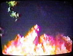 a television screen with flames in the background