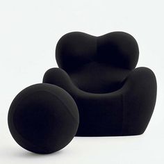 two black chairs sitting next to each other on a white surface