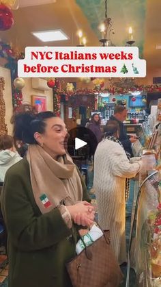 a woman standing in front of a store filled with christmas decorations