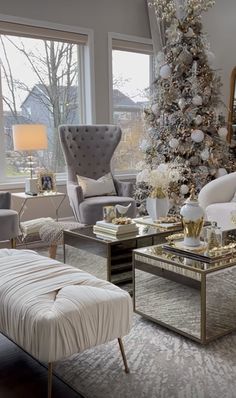 a living room filled with furniture and a christmas tree