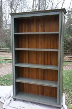 an old bookcase is being painted green