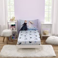 a bedroom with a bed, nightstands and white carpeted flooring in front of a purple wall