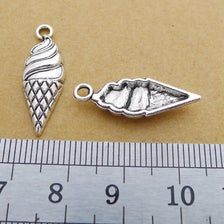 an ice cream cone charm is shown next to a ruler