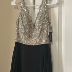 a dress hanging on a hanger in front of a door