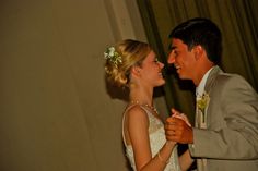 a bride and groom dance together at their wedding reception