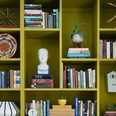 the bookshelf is filled with many different types of books and decorations on it