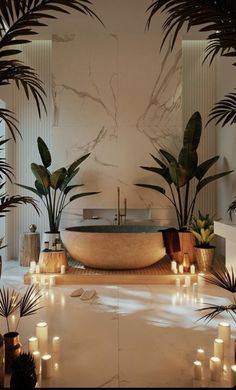 a bathtub surrounded by candles and potted plants