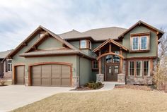 a large house with two garages in the front and one on the other side