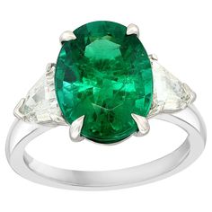 an oval emerald and diamond ring