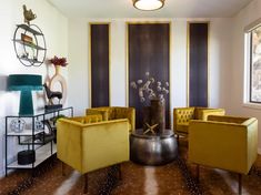 a living room filled with yellow chairs next to a window