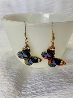 Beautiful colorful photorealistic butterfly dangle earrings with golden base and golden hooks! Welcome to my online jewelry shop; I am thrilled to have you here! My shop specializes in whimsical and unique earrings and other limited pieces, personally handmade by me. I appreciate you taking the time to visit and hope you enjoy browsing through my selection. I take great pride in my products and ensure that each pair of earrings comes with plastic backs to ensure they stay safely in place. Additionally, every pair of earrings comes with a velvet lined card and a drawstring gift bag, making them the perfect gift for a loved one or a treat for yourself. If you see a charm that you love on a pair of earrings, but would rather have it as a pendant on a necklace or a charm on a bangle bracelet, Multicolor Butterfly Earrings For Pierced Ears, Multicolor Butterfly Charm Earrings As Gift, Butterfly-shaped Hypoallergenic Hoop Earrings For Gifts, Nature-inspired Butterfly Earrings For Gift, Handmade Multicolor Butterfly Earrings, Butterfly Charm Wing-shaped Earrings For Gift, Unique Nickel-free Butterfly Earrings, Multicolor Butterfly Charm Earrings, Multicolor Butterfly Earrings