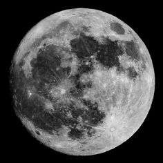 the full moon is shown in black and white