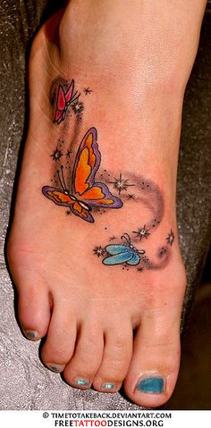 a woman's foot with an orange butterfly tattoo on her left side and blue flowers in the middle