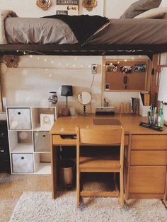 a bedroom with a bed, desk and shelves on the wall next to each other