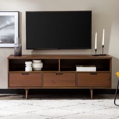 a flat screen tv sitting on top of a wooden entertainment center