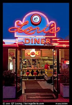 the front entrance to a diner at night