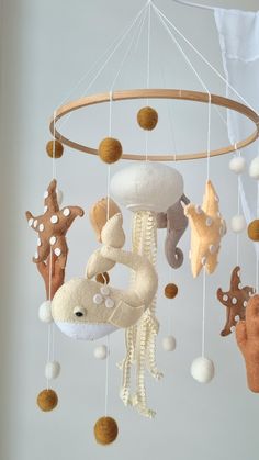 a baby crib mobile with sea animals hanging from it