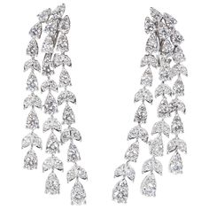 A stunning pair of earrings! Almost 7 carats of sparkle! 6.87 carats of round brilliant cut diamonds set in pear and marquise shaped 18k white gold. The round stones give the earrings more sparkle and a unique look. Approximately half an inch wide and 2 inches at its longest point Please contact us for more information. Pearl Chandelier Earrings, Diamond Chandelier Earrings, Gem Earrings, Diamond Dangle Earrings, Sparkle Jewelry, Expensive Jewelry, Antique Earrings, Diamond Drops, Diamond Drop Earrings