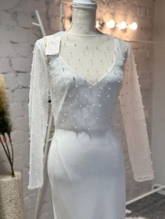 a white dress on display in a room