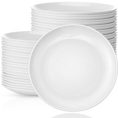 a stack of white plates stacked on top of each other in front of a white background