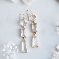 "These beautiful 70s style inspired statement earrings are sure to add a retro vibe to your wedding day. The 14k gold filled earring wires are secured to clear faceted glass set inside of golden bezels. These charming earrings are accented with bell bottom shaped glass for a unique vintage look. Whether searching for the perfect wedding earrings for your modern day vintage style wedding, a best friend gift, maybe bridesmaids earrings, or something for your next special occasion, all of my jewelr Modern Dangle Bridal Earrings For Party, Vintage White Drop Bridal Earrings, Modern Wedding Crystal Drop Earrings, Modern Crystal Drop Earrings For Wedding, Modern Clear Earrings For Wedding, Modern Chandelier Drop Earrings For Wedding, Vintage White Bridal Earrings For Weddings, Vintage White Bridal Earrings For Party, Modern Dangle Linear Earrings For Wedding