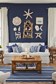 a living room with blue walls and white furniture in the center, along with starfish decorations on the wall