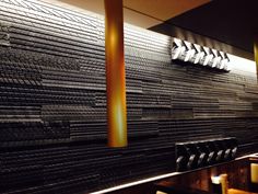 a restaurant with black and white tiles on the wall