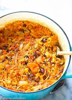 a blue pot filled with rice and beans