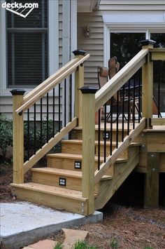 a wooden deck with stairs and railings