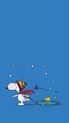 a snoopy dog is playing tennis in the snow