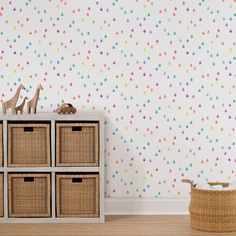 a wallpapered room with blue and green flowers on the wall next to baskets