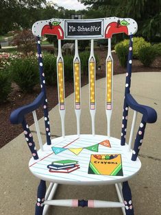 a child's rocking chair with toothbrushes painted on the back and sides