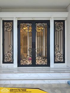 the front door to a house with wrought iron doors and glass panels on both sides