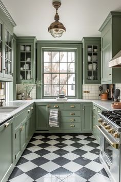 a kitchen with green cabinets and black and white checkerboard flooring on the walls