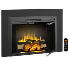 an electric fireplace with fire logs and remotes next to it on a white background