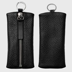 two black leather zippered cases with metal rings