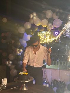 a man standing in front of a birthday cake