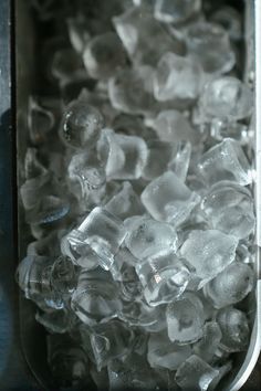 ice cubes in a metal container on a table