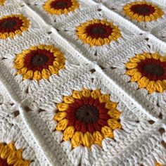 a crocheted blanket with sunflowers on it