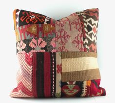 a multicolored patchwork pillow on a white background