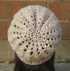 a woman wearing a crocheted hat with holes on the front and back of her head