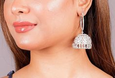 Make a bold fashion statement with our exquisite collection of American Diamond Jhumka earrings. Choose from a variety of styles, including the unique flair of Hoop Jhumka or the traditional charm of India Earrings. Add a touch of sparkle with CZ Jhumka or embrace the cultural richness of Bali Jhumka. Elevate your look with these stunning pieces and radiate elegance wherever you go. *𝐏𝐑𝐎𝐃𝐔𝐂𝐓 𝐃𝐄𝐓𝐀𝐈𝐋* * Material: Brass * Plating: White Rhodium Plated * Stone: AAA Quality CZ Diamond. * Bridal Earrings For Diwali, Heavy Bridal Earrings For Festive Occasions, Elegant Danglers For Navratri, Heavy Danglers For Celebrations, Heavy Jhumkas For Festive Occasions, Elegant American Diamond Jhumkas, Glamorous Danglers For Wedding, Navratri Bridal Earrings, Round Tilla Jhumkas