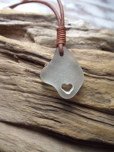 a piece of sea glass with a heart on it