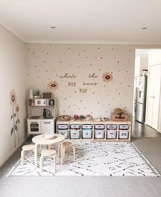 a living room with sunflowers on the wall and storage bins in front of it