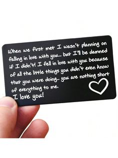 someone is holding up a black card with a white heart on it that says, when we first met i want't planning on falling in love with you